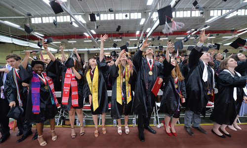 Members of the Denison Class of 2018 toss their mortarboards