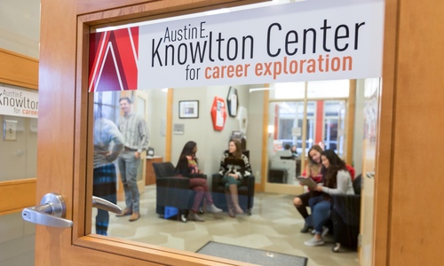 A view of the Knowlton Center for Career Exploration entrance with several students gathered in the lobby.