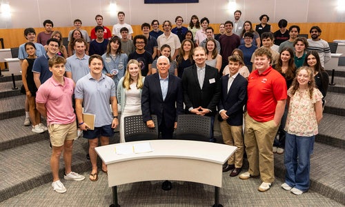 Vice President Mike Pence poses for a group photo with a large group of students.