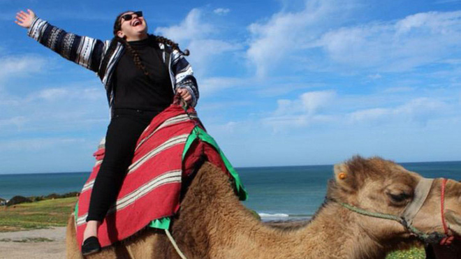 Student riding a camel