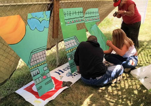 People painting big letters