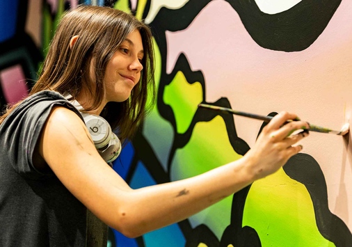 Mel painting a mural