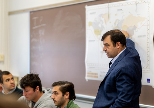 Scott Smitson in a classroom pointing at a map