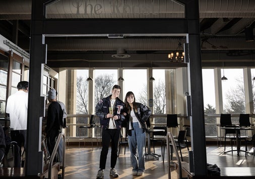 Two students pose for a photo in the student union.