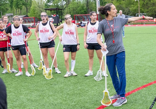 A group of players from Denison Women's Lacrosse at practice with coach Amanda Daniels.