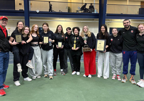 Denison fencers and coaches pose for a group photo celebrating their Eastern Women's Fencing Conference win.