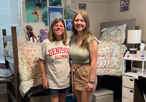 Michele Walton Hoehn '89 with her daughter Kare '29 standing in a college dorm room.