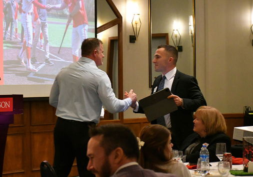 Denison coach Mike Deegan greets former Denison pitcher Matthew Zmuda at the First Pitch Banquet.