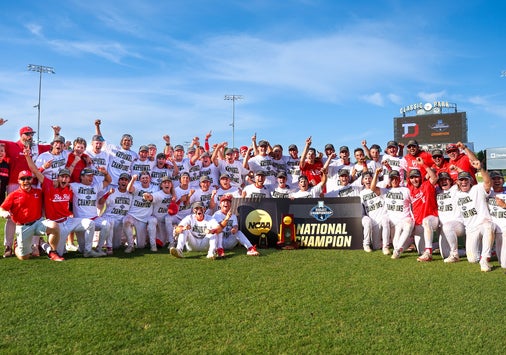 The Denison baseball team poses for a photo with their national championship trophy.