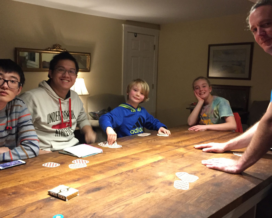 Henshaw family and students playing board game