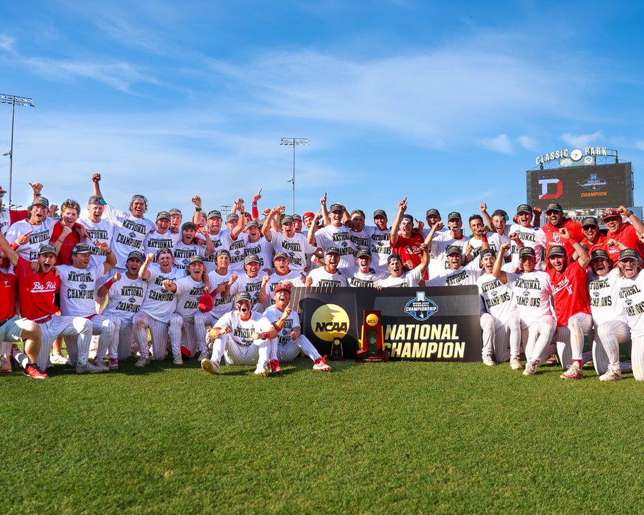 The Denison baseball team poses for a photo with their national championship trophy.