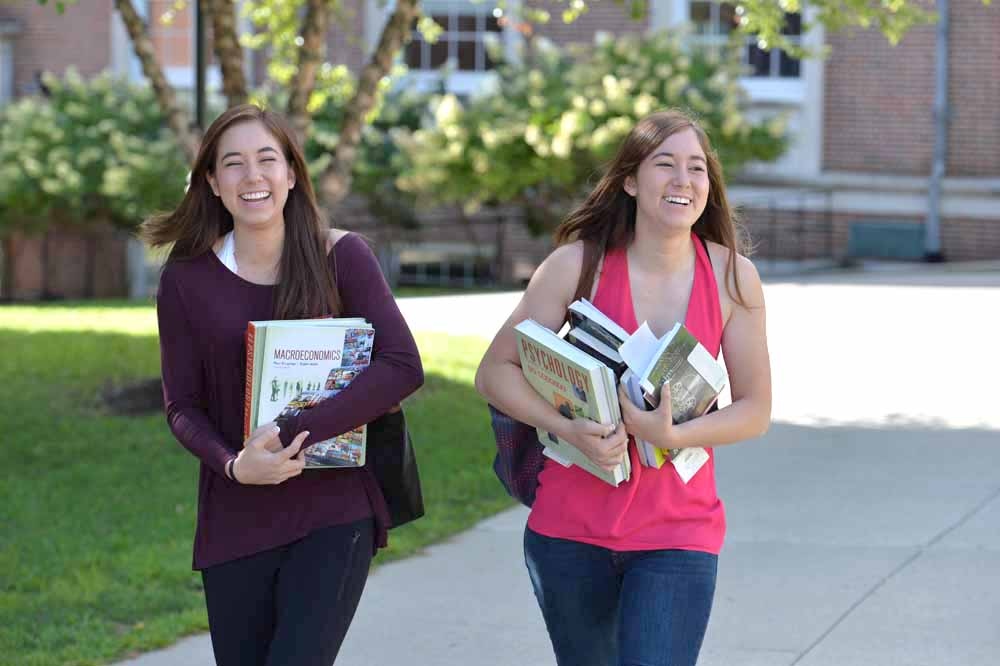 two Denison students walking on the quad during the start of the fall 2016 semester