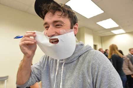 student with paper beard
