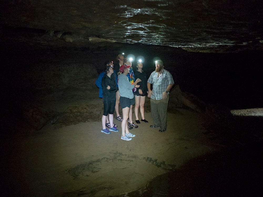 Students in a dark cave