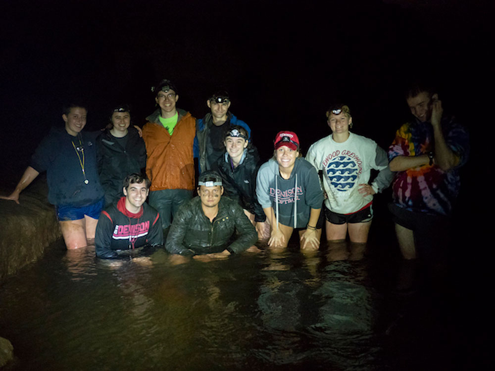 Group photo of students in dark cave