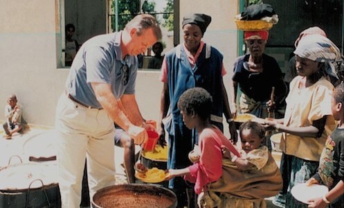 Tony Hall feeding children