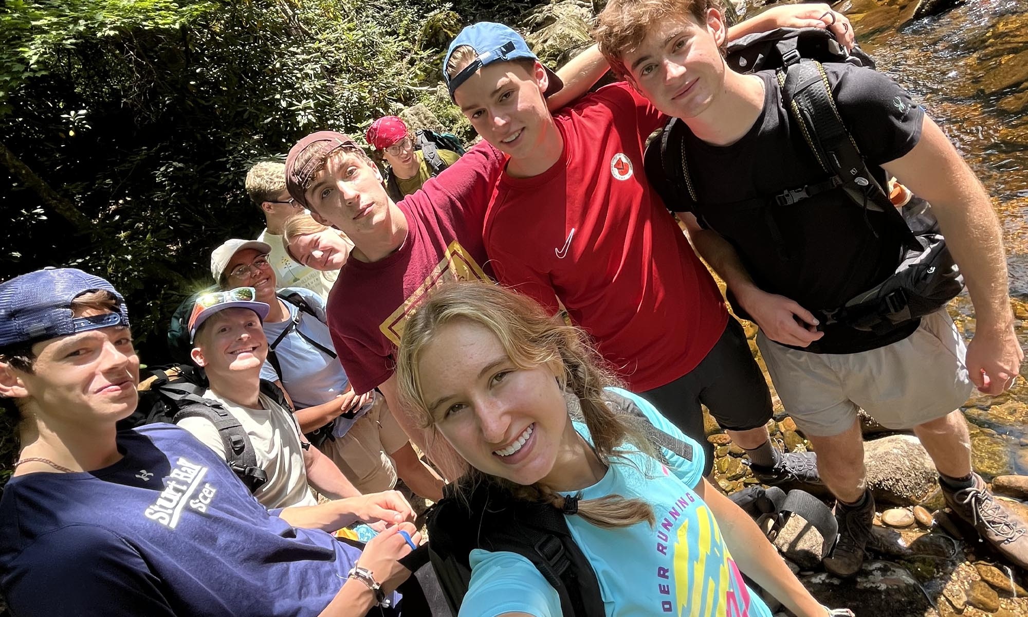 Students posing for a selfie on a hike.