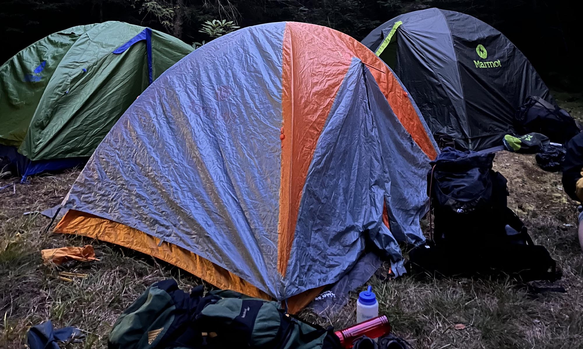 Image of several tents set up at a campsite.