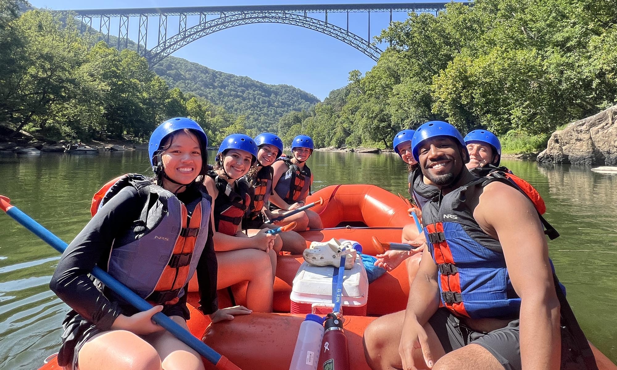 Student white water rafting on the river.