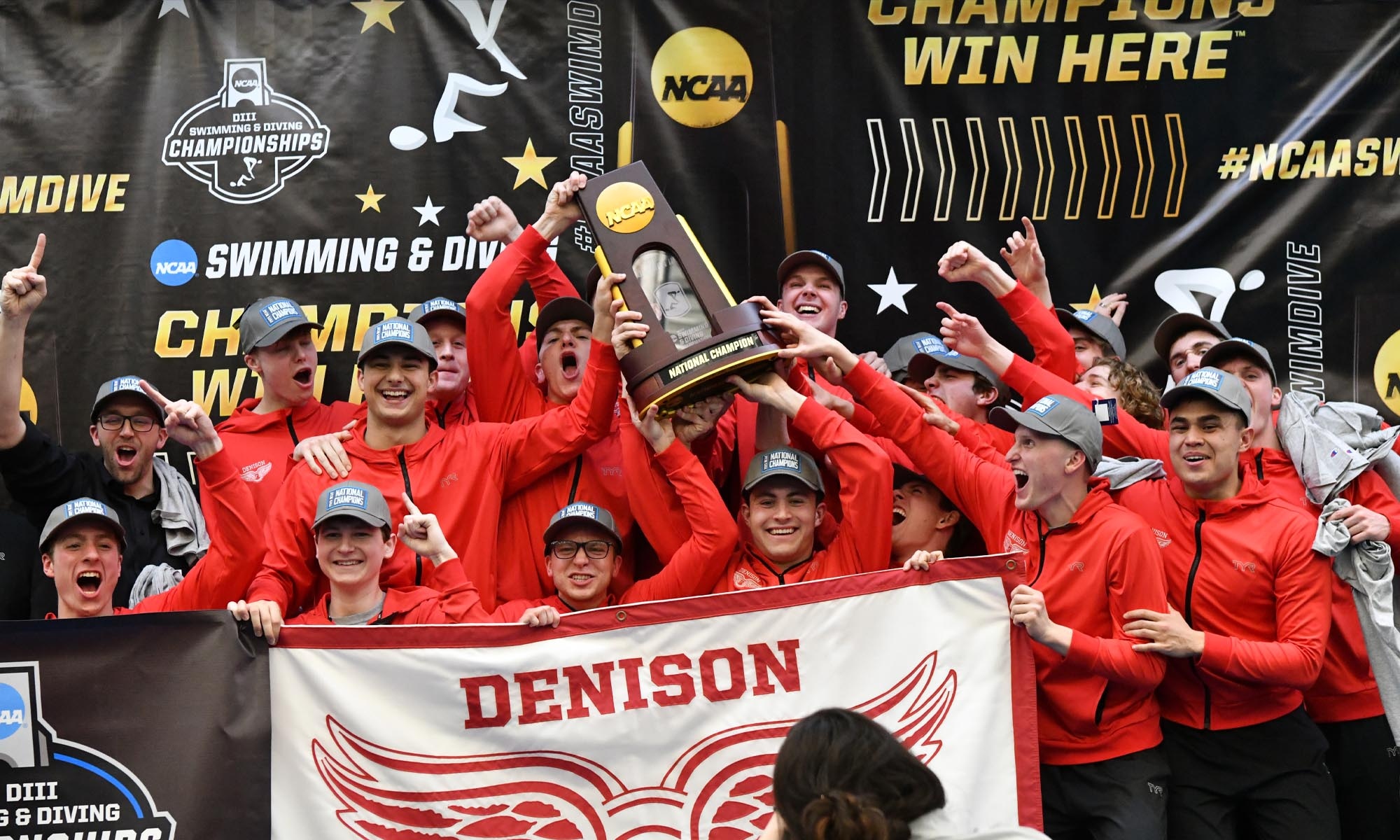 Men's Swimming & Diving team pose with their national championship trophy.