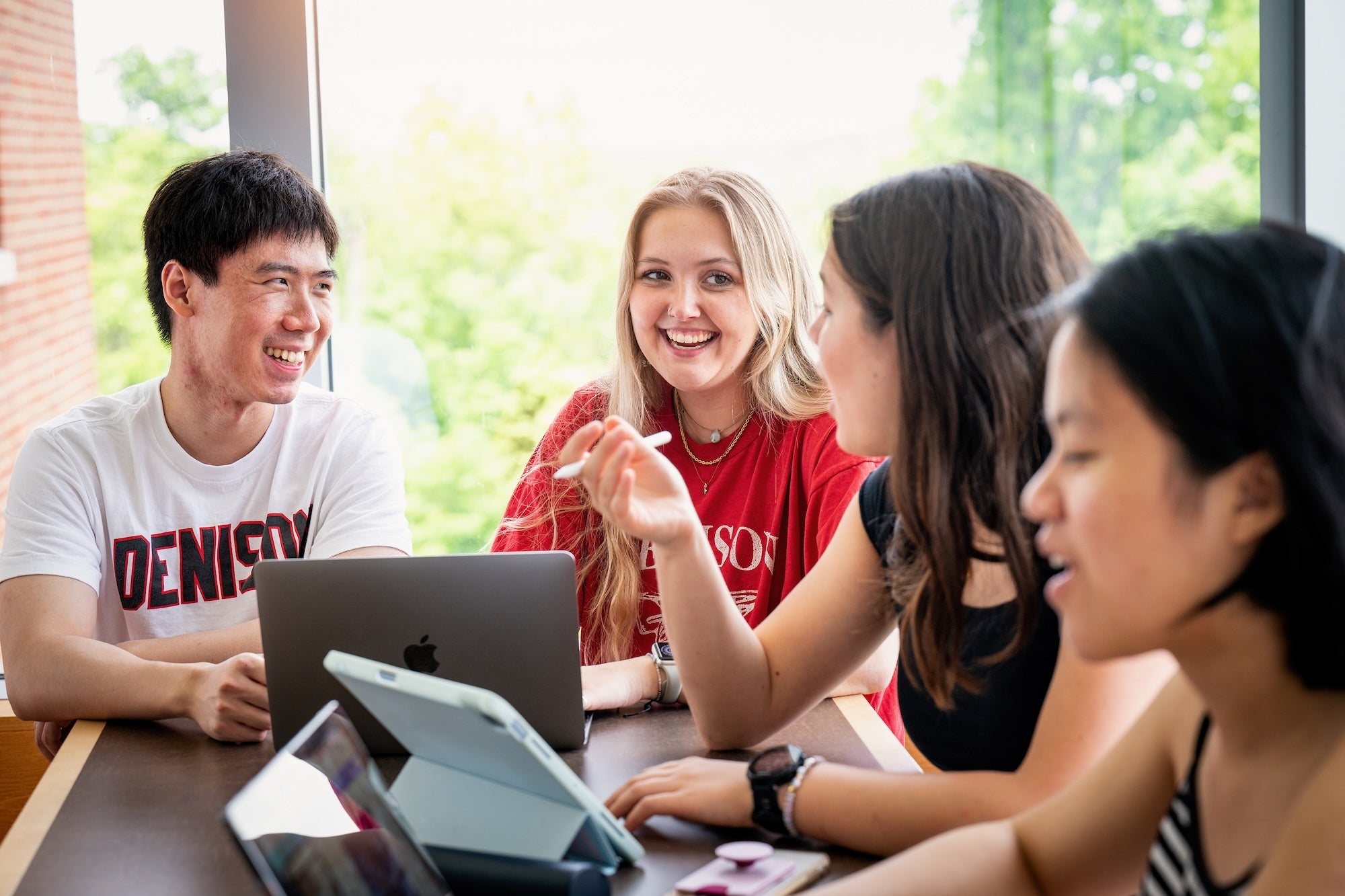 Students hanging out while working on their laptops