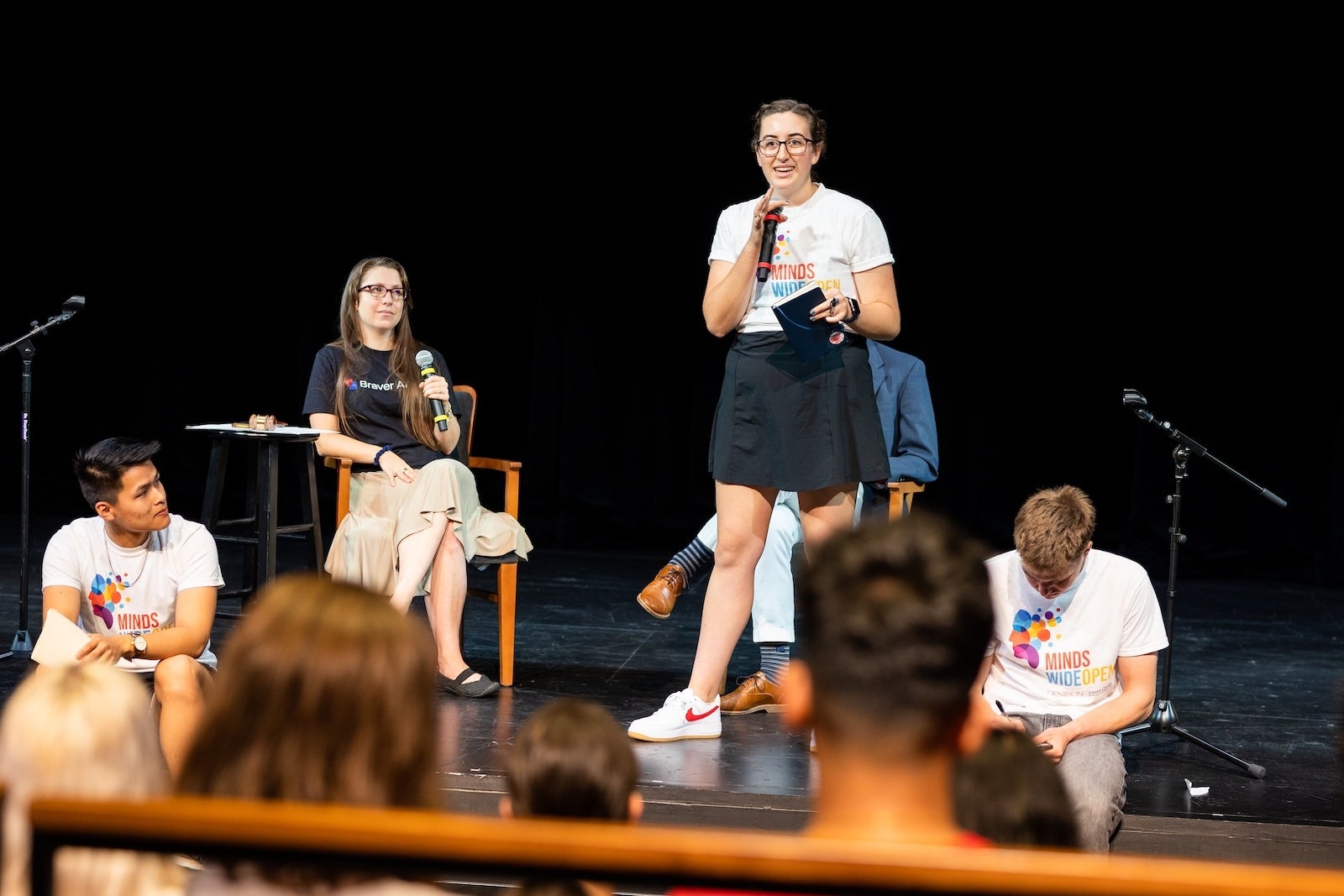 Students wearing Minds Wide Open t-shirts on stage