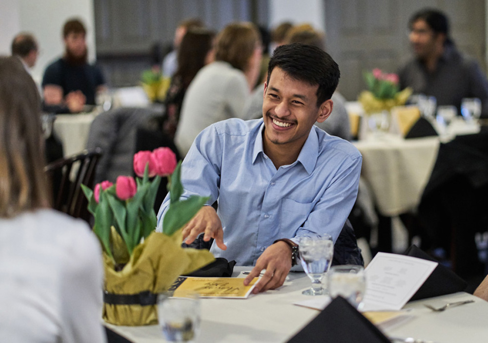 student smiling during dinner