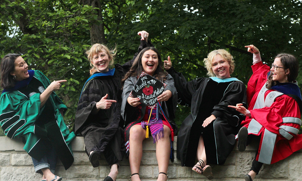 Kristen Ago '19 with her professors at Graduation