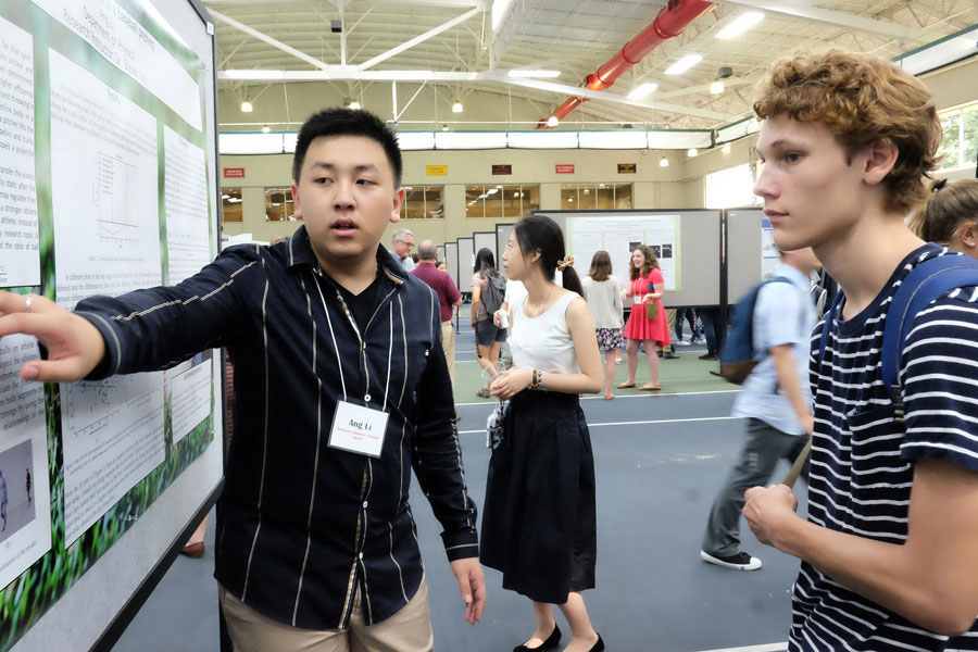 Student explaining his poster