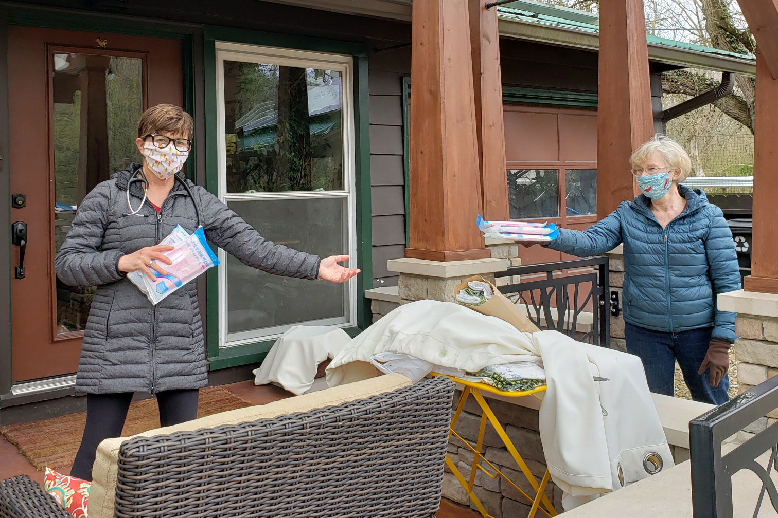 Two volunteers making masks