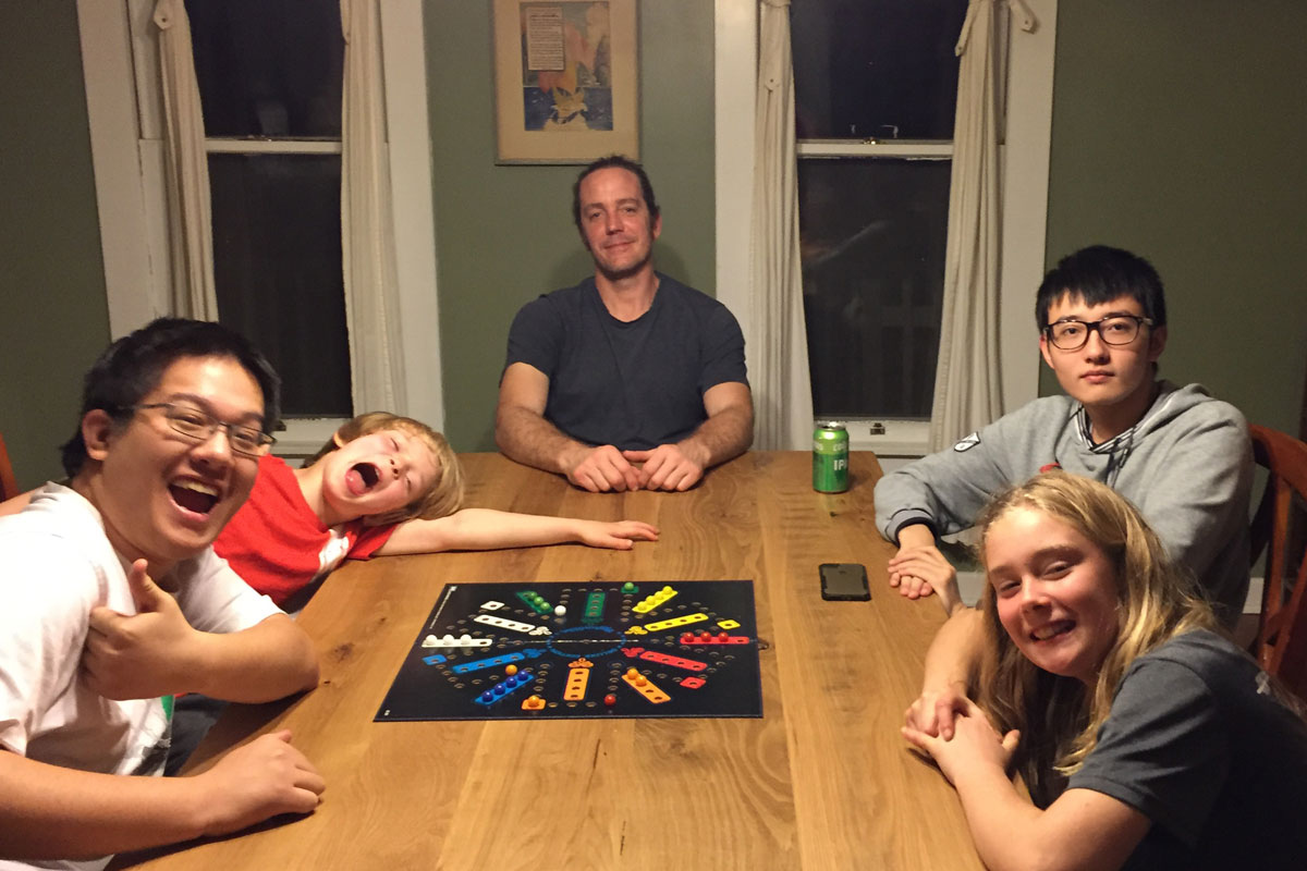 Family and students playing board games
