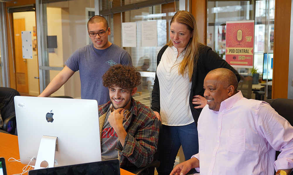 Professor and students work on an audio stories for the Podcast-a-thon