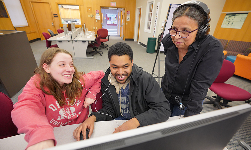 Professor and students work on an audio stories for the Podcast-a-thon