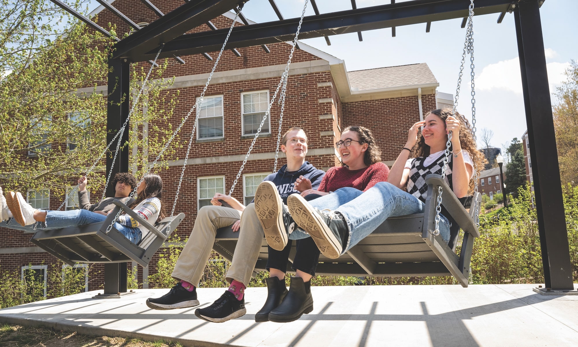 Students on the Swings by Silverstein Hall