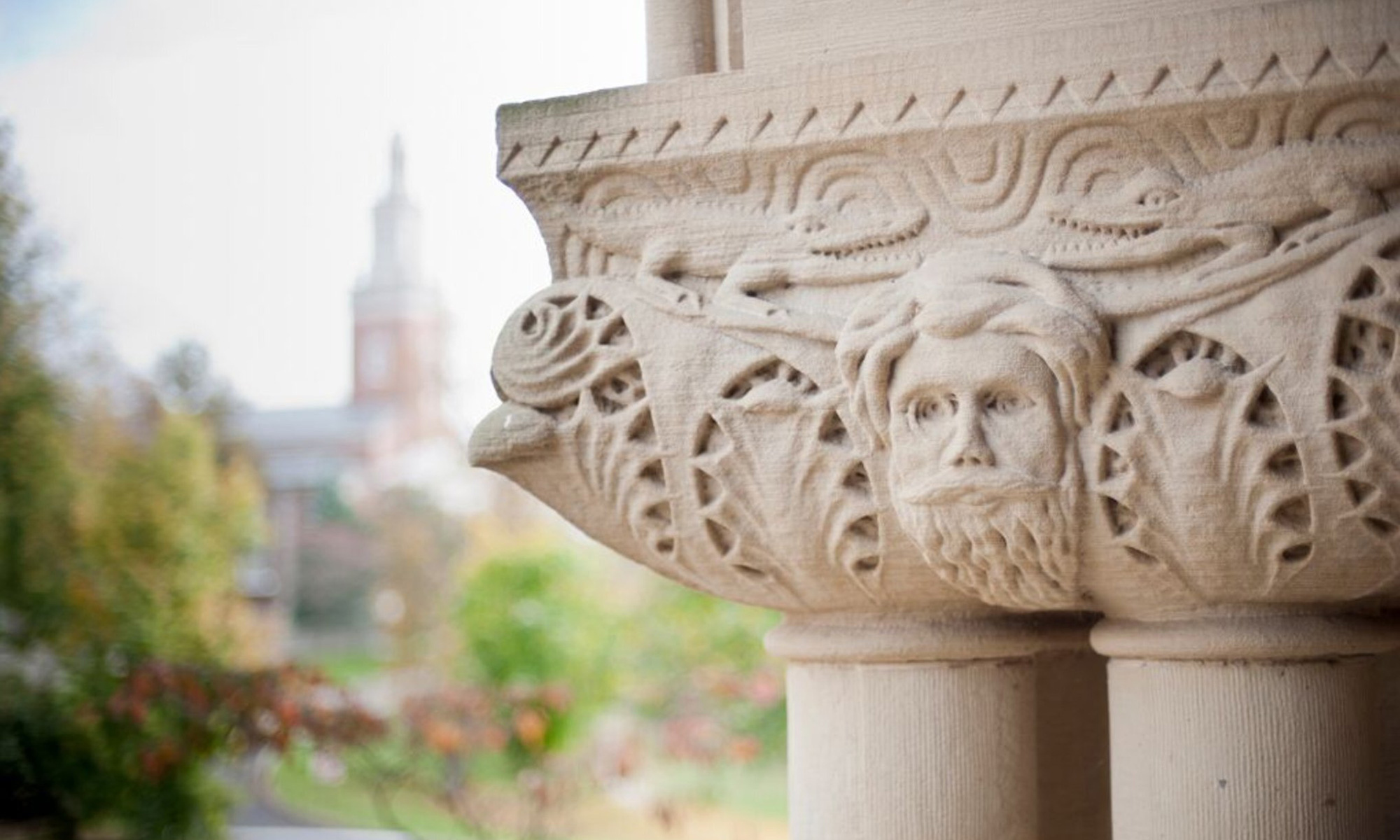 Carvings on the pillars of Doane with Swasey Chapel in the background