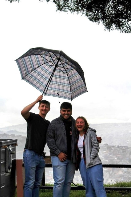 three students with umbrella
