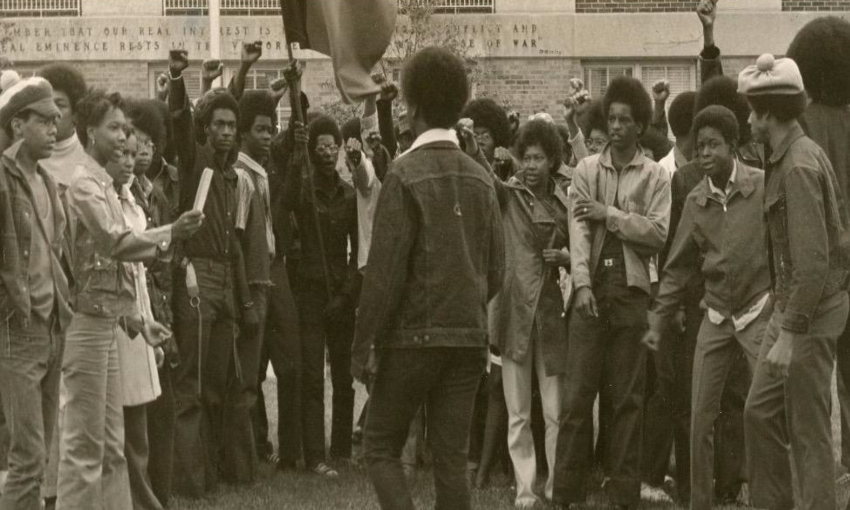 Crowd of people gathered around man in protest