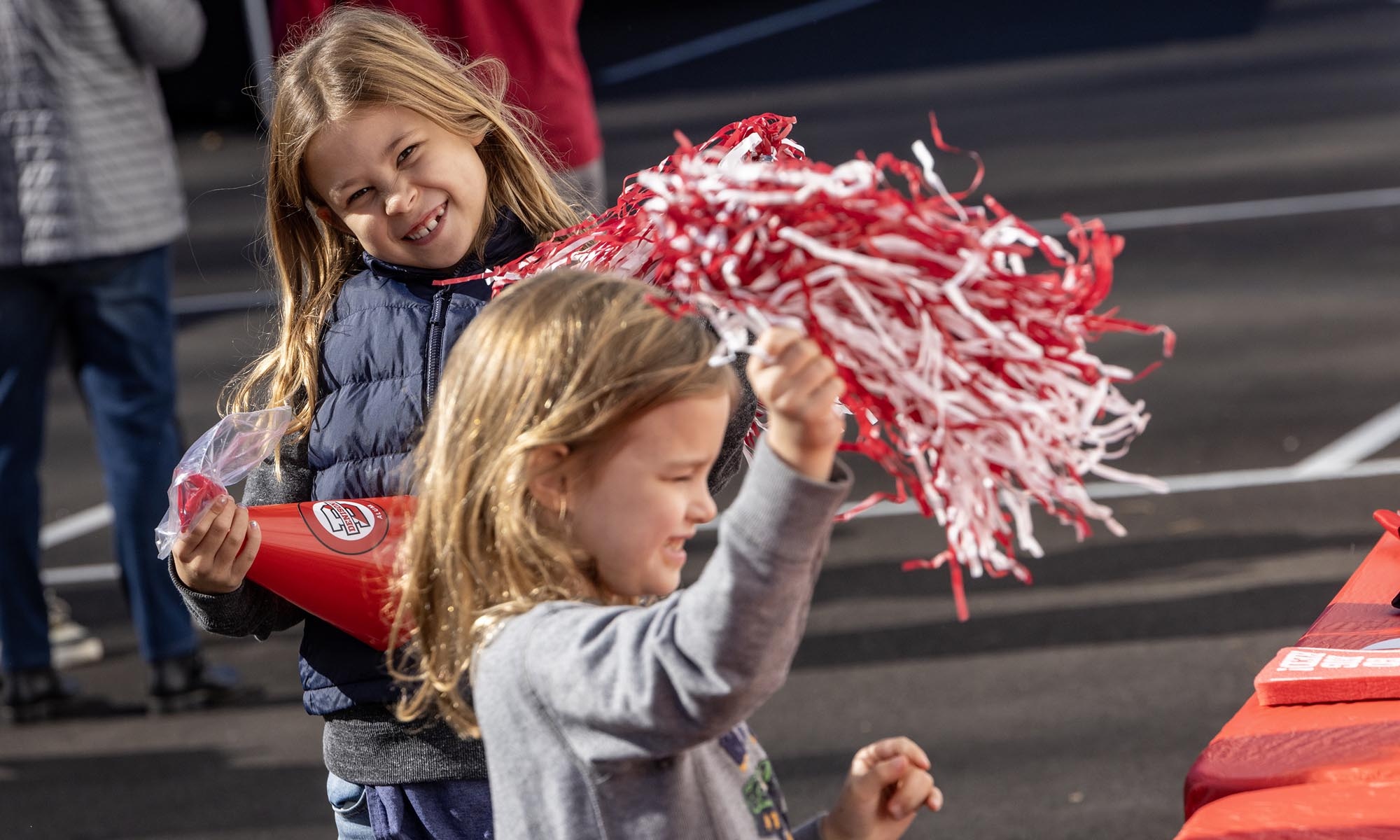A young Denison fan waving red and white pom poms