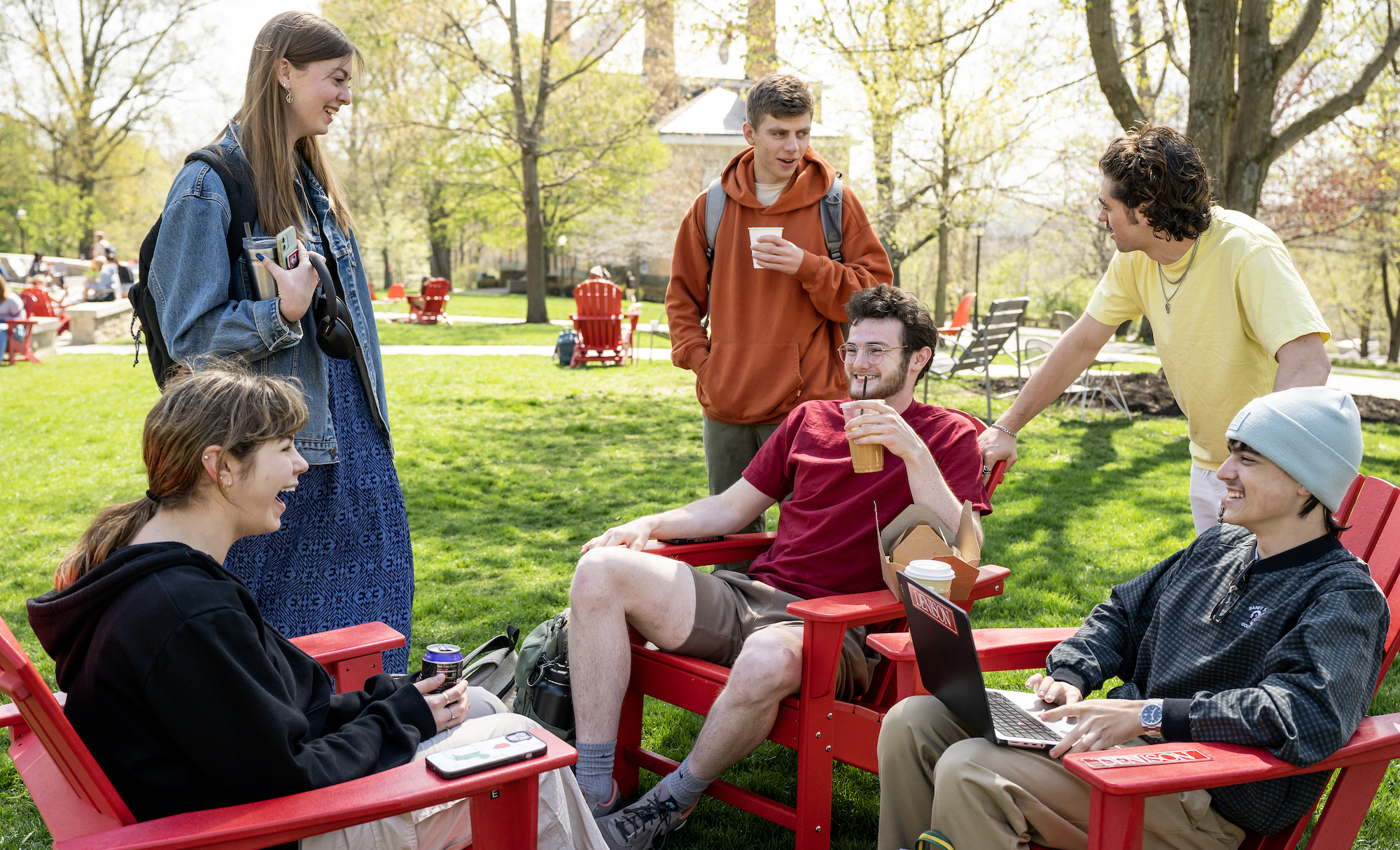 https://denison.eduPicture of college students sitting on chairs outside and having a conversation