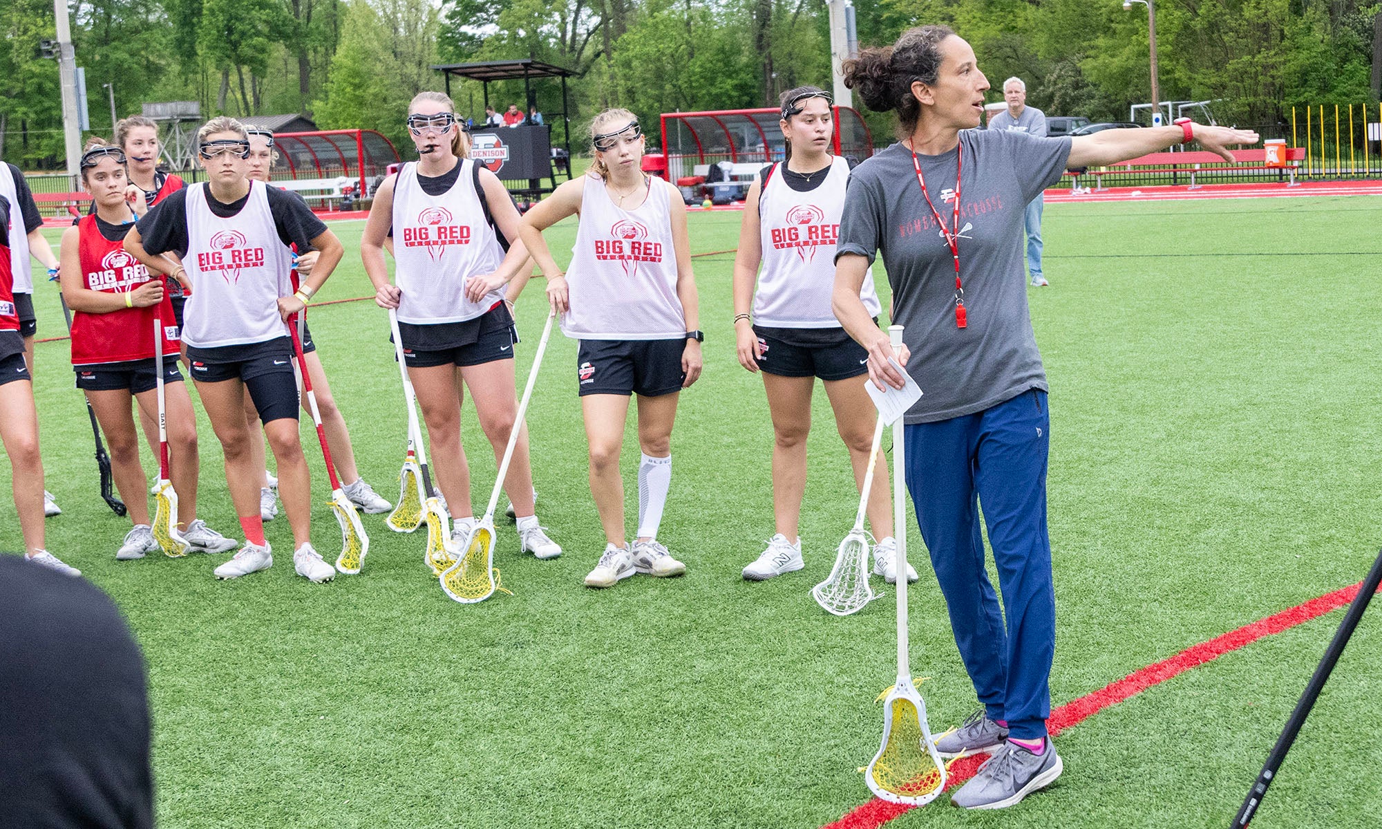 A group of players from Denison Women's Lacrosse at practice with coach Amanda Daniels.