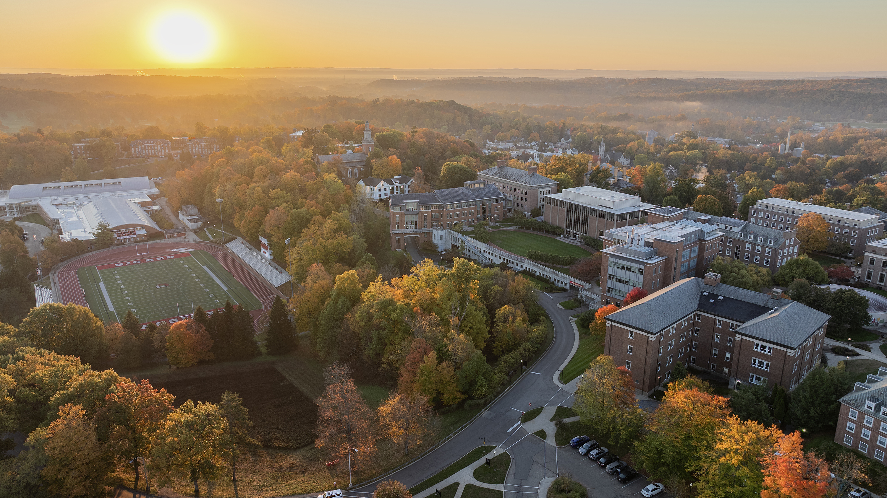 A drone image shows portions of campus during sunrise.