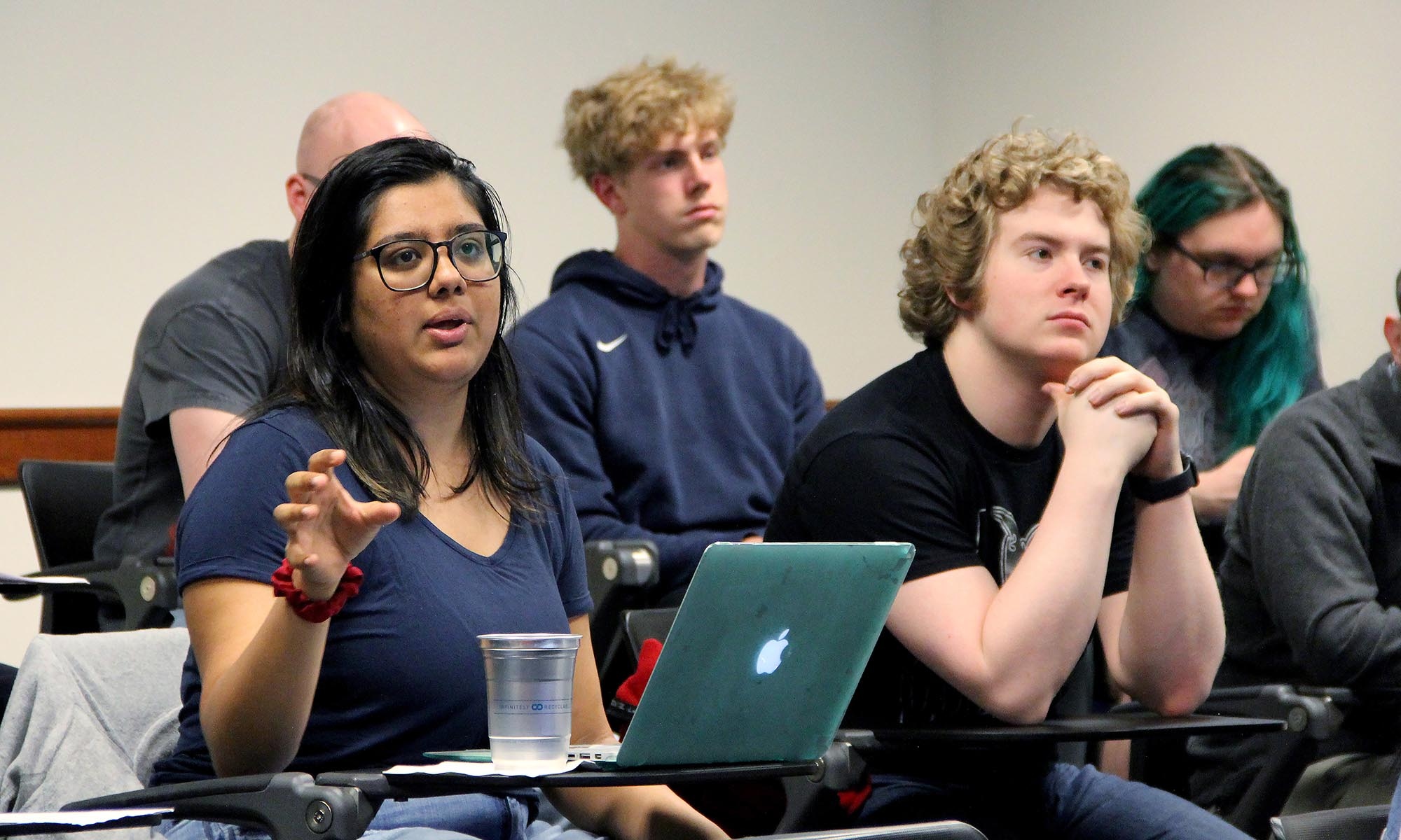 Students sitting in a classroom lecture listening to a seminar speaker..