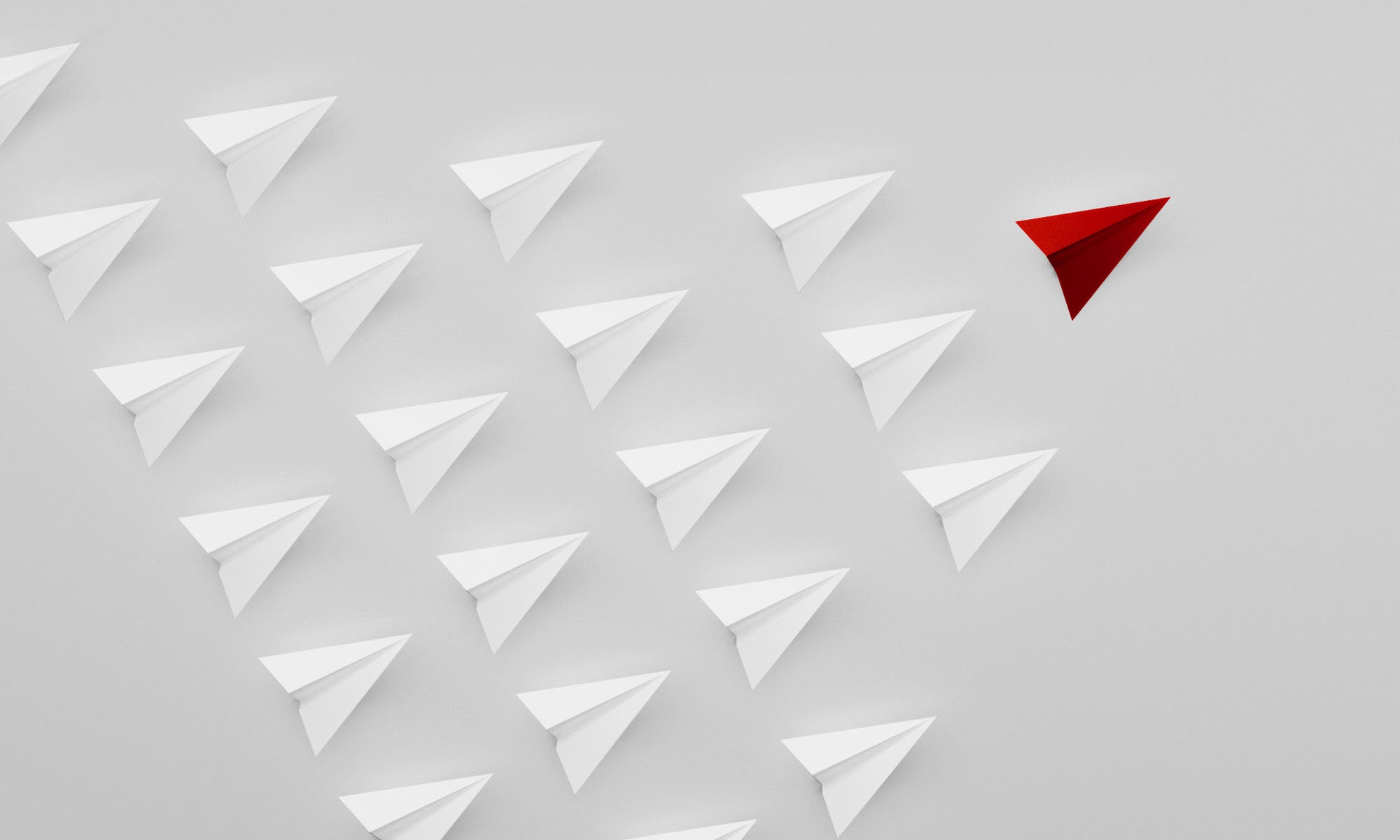 Illustrations of a several cursor-shaped white triangles forming a V formation with a red triangle at the forefront.