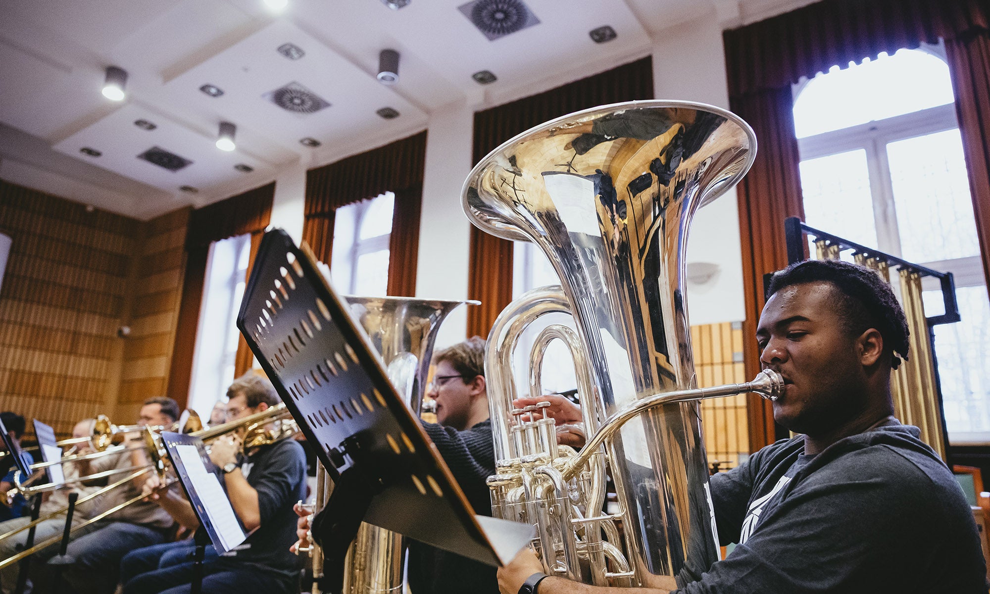 A tuba player practicing with the ensemble.