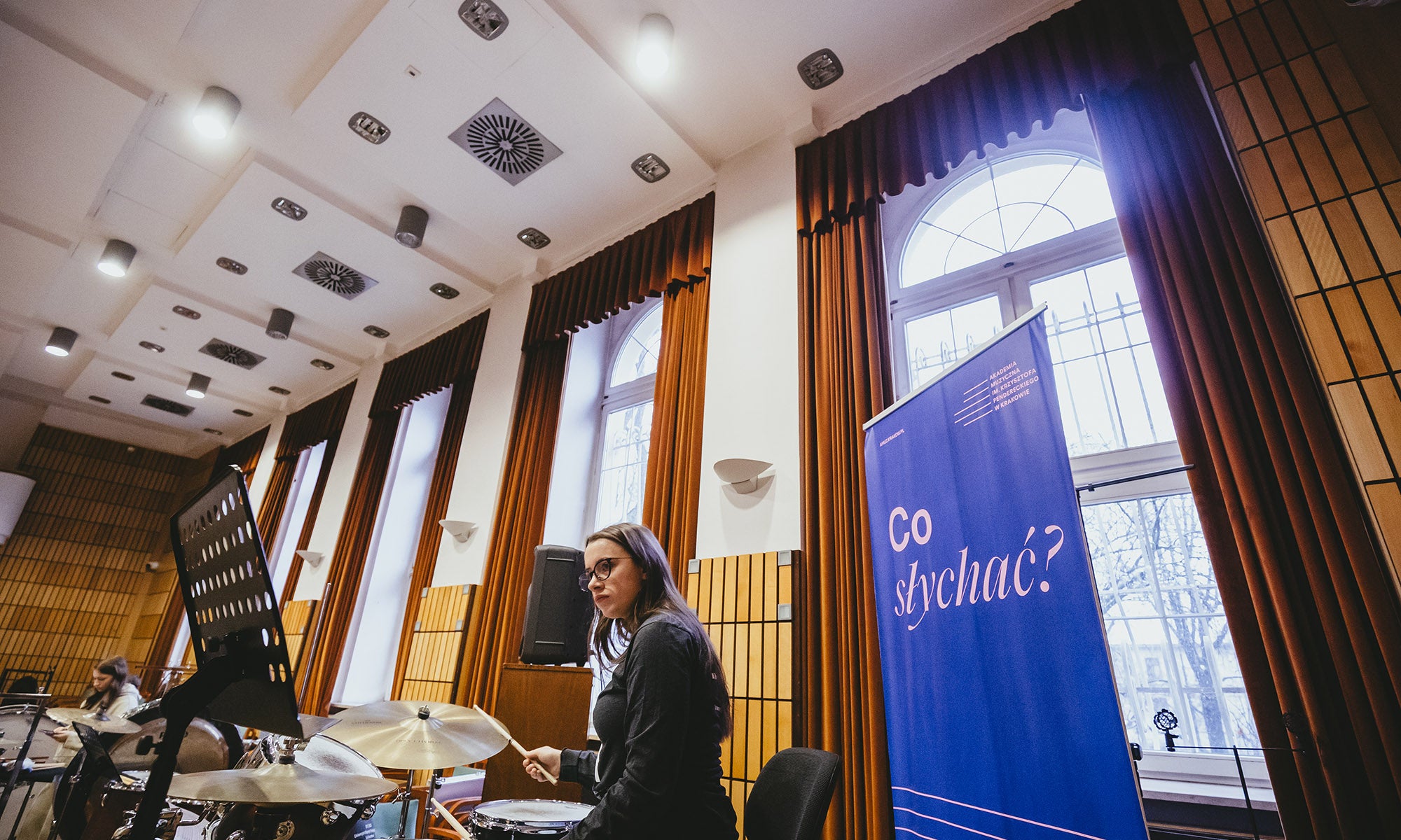 A percussionist practices with the ensemble.