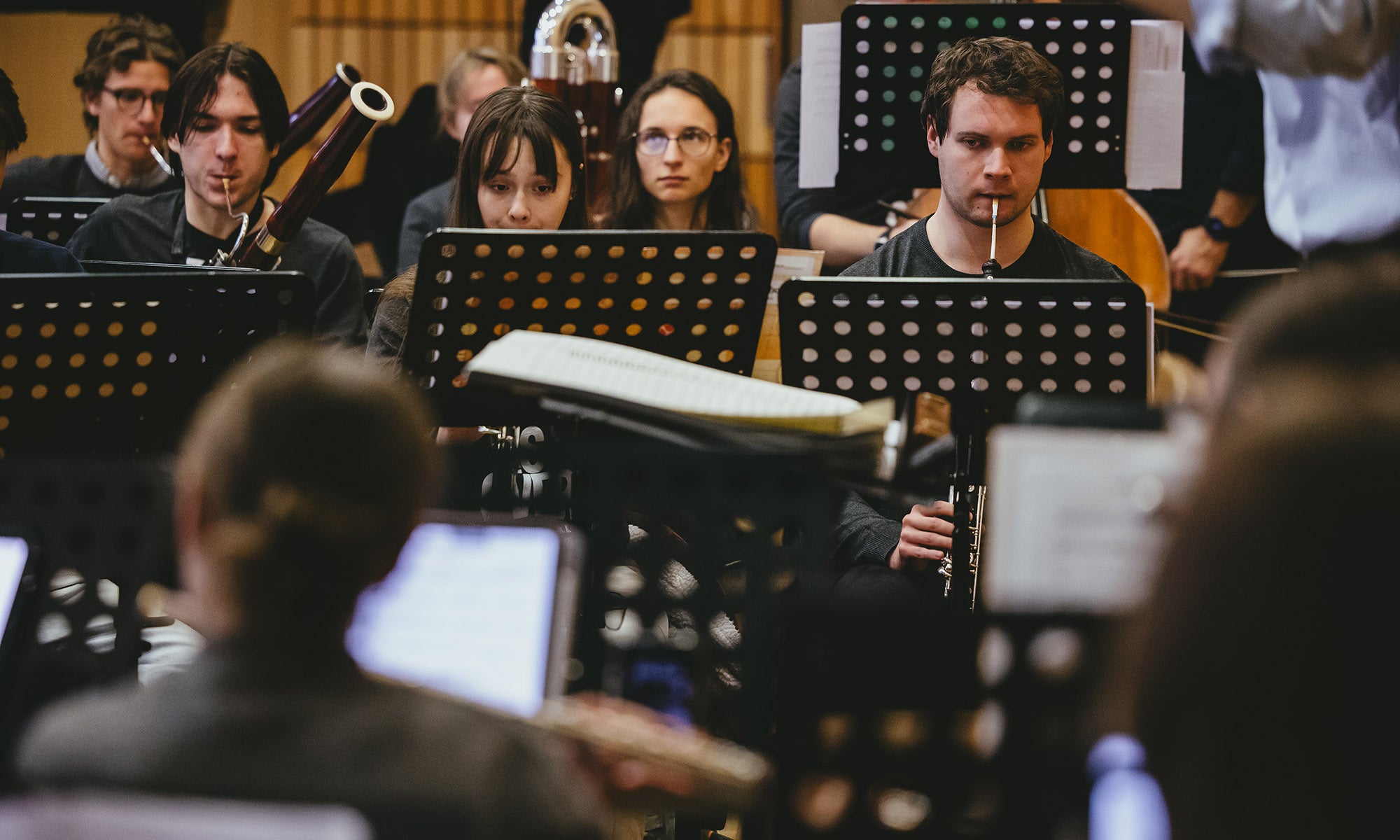 Ensemble members rehearse for a concert.