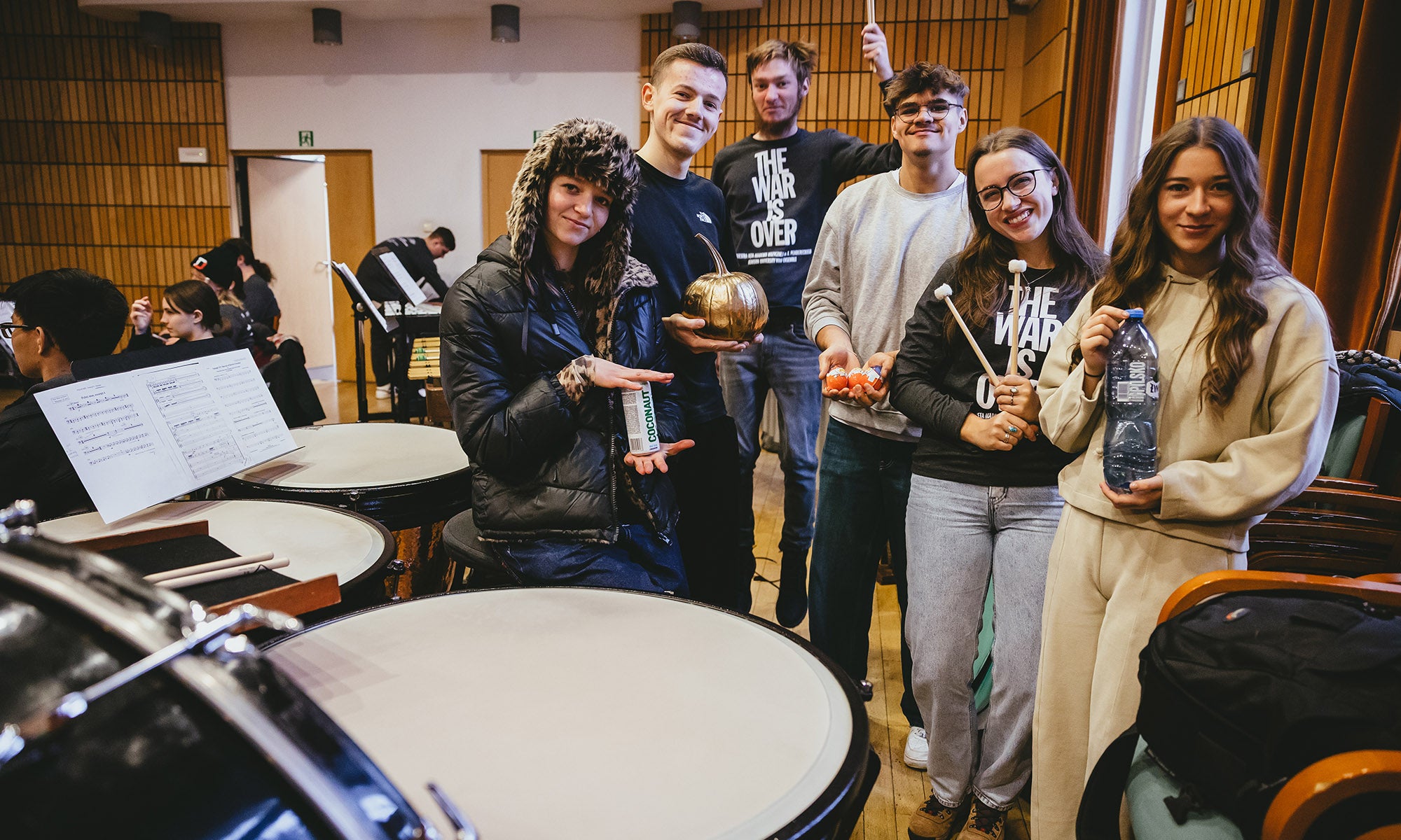 A group of musicians pose for a photo by the percussion instruments.