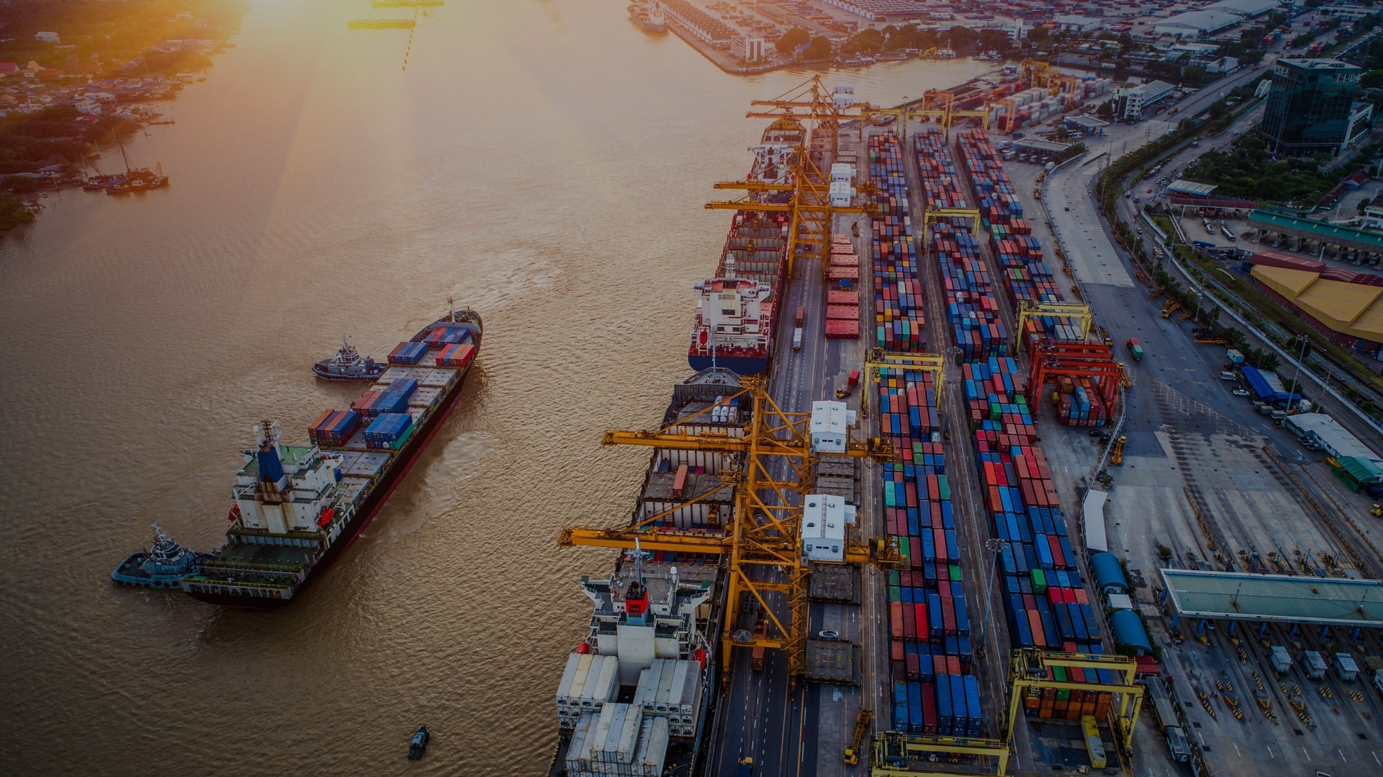 Logistics and transportation of Container Cargo ship and Cargo plane with working crane bridge in shipyard at sunrise, logistic import export and transport industry background