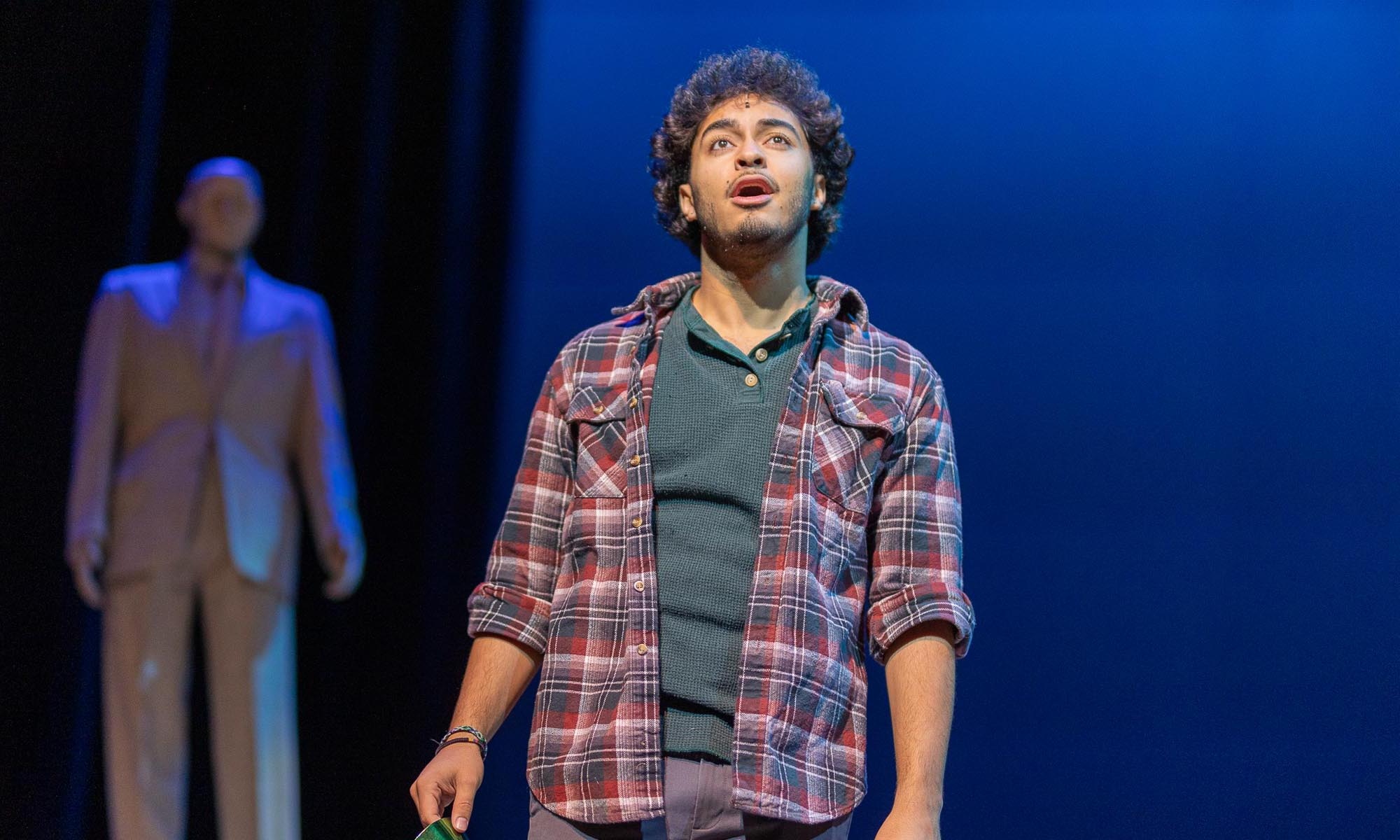 Denison Music Theatre student stands center stage and sings.