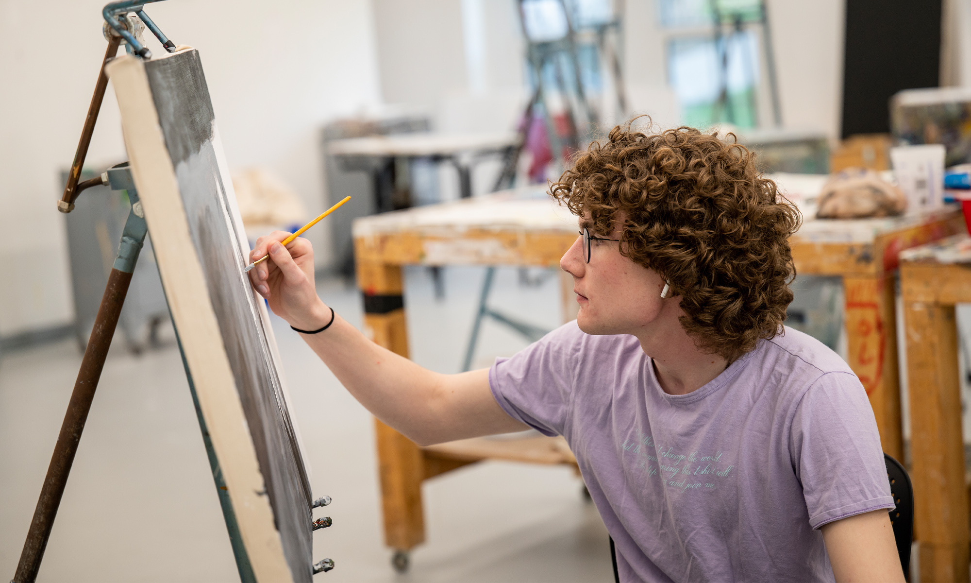 A student paints in the studio